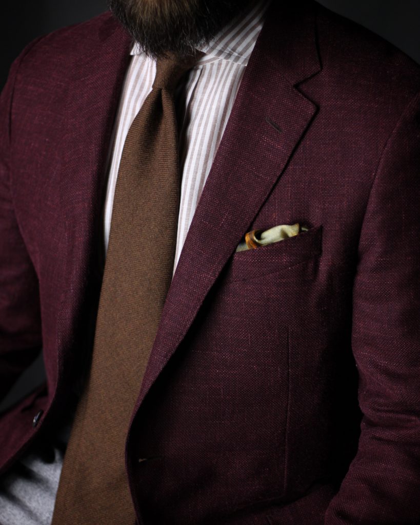 brown stripe, brown tie, burgundy jacket, pocket square, red and brown